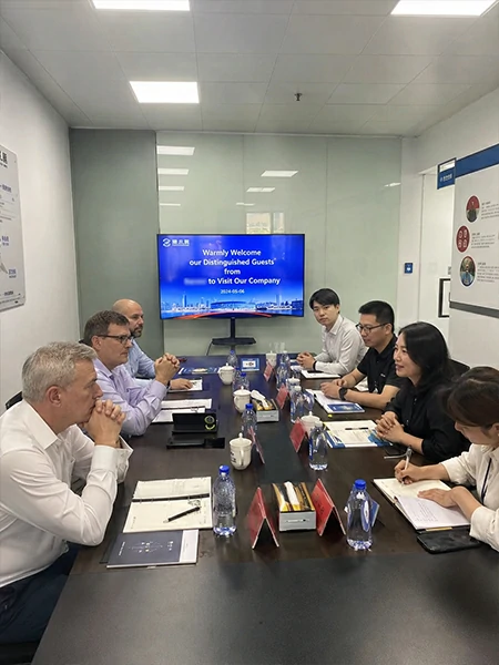 Business visitors discussing supplier meetings factory visits and local schedules in China