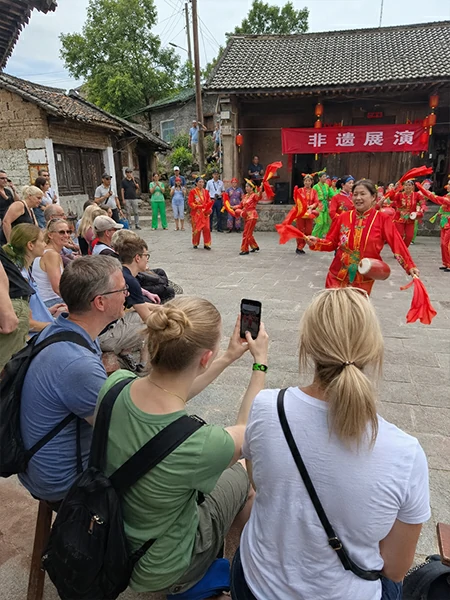 Traveler watching a traditional Chinese heritage performance during a cultural experience in China