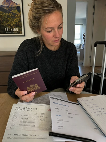 Traveler checking visa entry documents and arrival steps before traveling to China