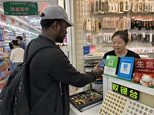 Visitor having trouble paying with QR codes mobile payment cards and cash