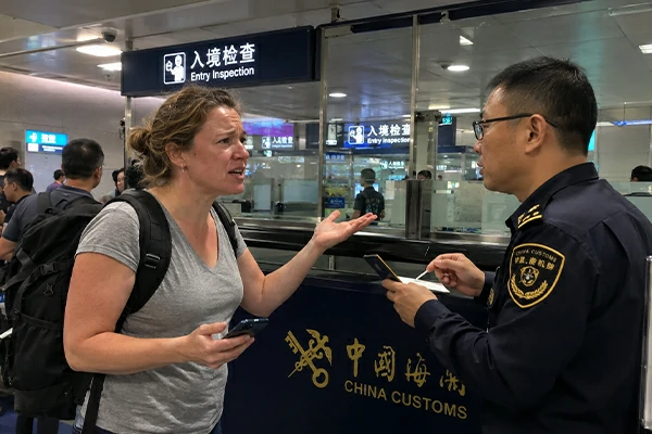 Traveler reviewing passport visa documents arrival steps and hotel registration details